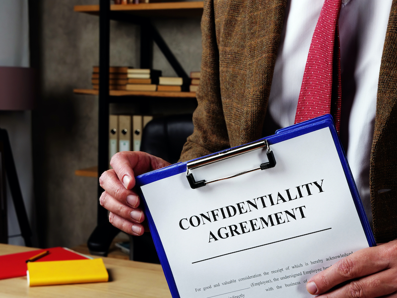 Man Holding Confidentiality Agreement Clipboard