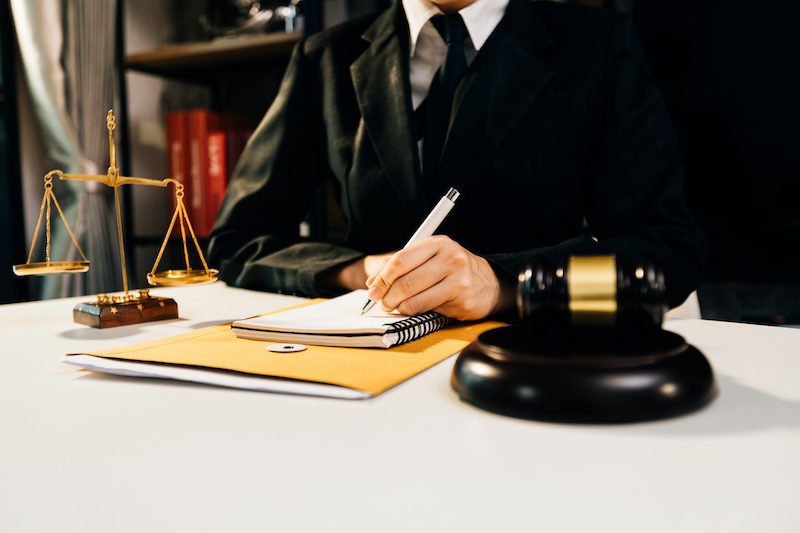 Lawyer Writing At Desk