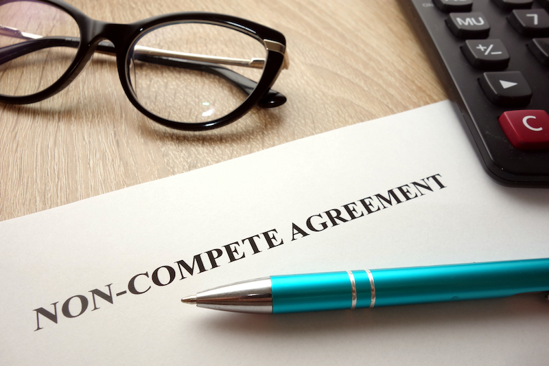 Non-Compete Agreement With Pen and Glasses